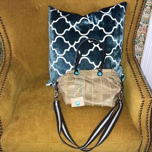 A convertible leather crossbody bag with handles